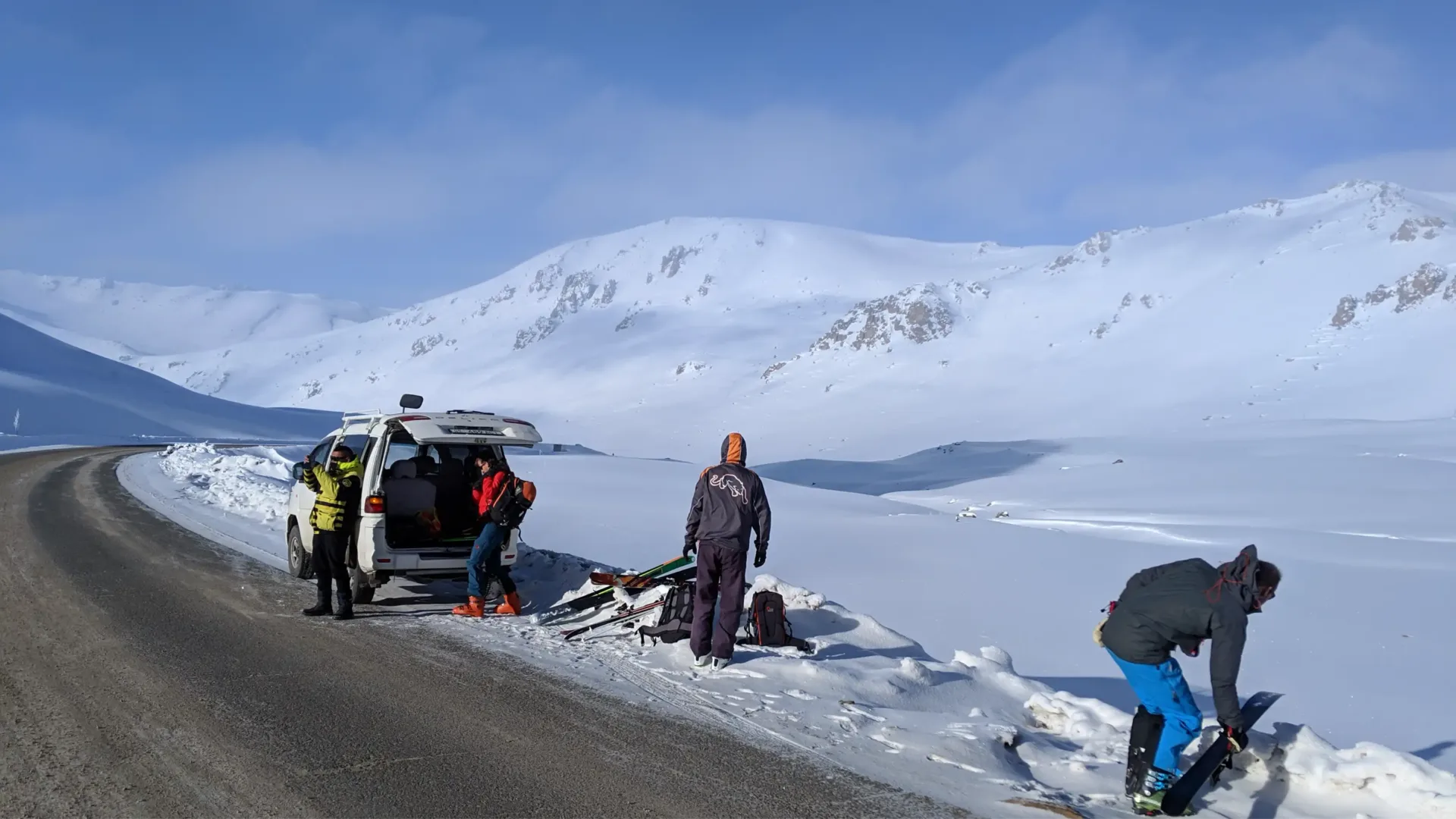 Backcountry skiers on a snowy mountain slope in Kyrgyzstan