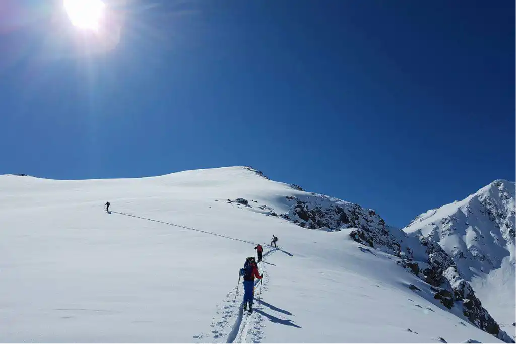 Ski touring group ascending a mountain in Kyrgyzstan